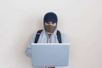 man with laptop in hands and mask
