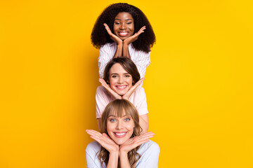 Photo of nice optimistic three ladies hands face wear white shirt isolated on bright yellow color background