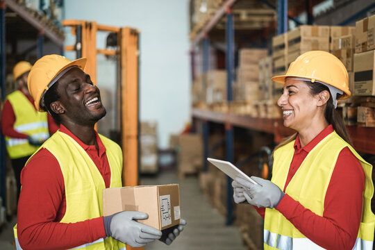 Happy Multiracial Workers Having Fun Inside Warehouse - Focus On Woman Face