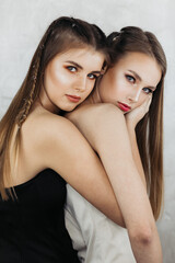 Two female models with beautiful makeup posing in fashion beauty style.