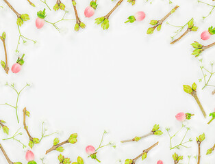 Spring background of  small twigs with buds and pink berries on light backdrop with blank circle in the middle