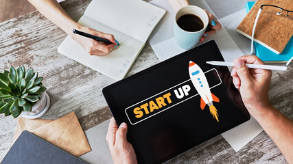 Start up spaceship on device screen. Business and finance concept.