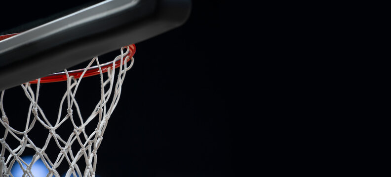 Empty Swooshing Basketball Net Close Up with Dark Background. Sports background for product display, banner, or mockup.
