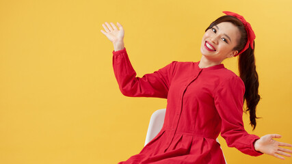 Positive young beautiful female with straight hair in ponytail dressed in casual clothing looking at camera and pleasantly smiling, rejoicing life