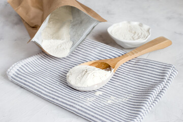 Crumbly xanthan gum in a wooden spoon.