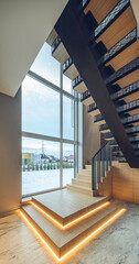 Wooden staircase with illumination in luxury private house. Interior.