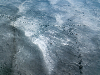 Frosty pattern on ice. Aerial drone top view. Sunny winter day.