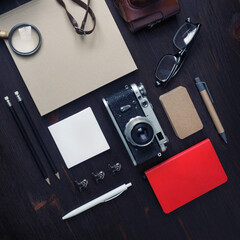 Overhead view of vintage stationery and retro camera on wooden background. Top view. Flat lay.