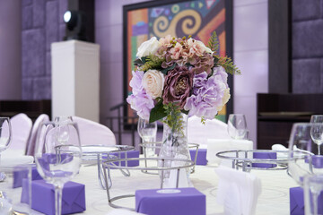 Beautiful table setting for wedding celebration in restaurant. Empty glasses and white napkins are installed in the restaurant on the table. Part of the interior. Elegant table set