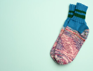 a pair of warm comfortable knitted socks on a green background
