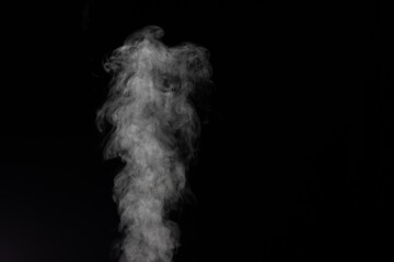 White smoke on black background. Figured smoke on a dark background. Abstract background, design element, for overlay on pictures