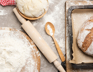 white wheat flour heaped on a round wooden board