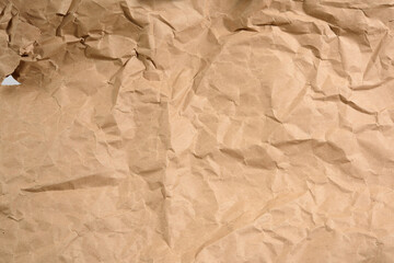 brown crumpled paper with torn holes, full frame