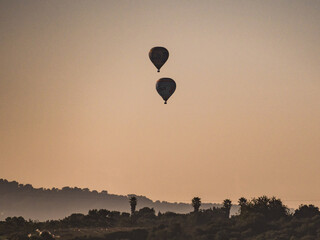 hot air balloons at sunset in majorca, spain