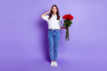 Photo of surprised crazy lady hold red roses open mouth wear white shirt isolated violet color background