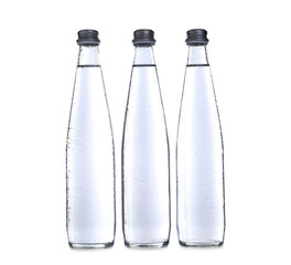 Glass bottles with soda water on white background
