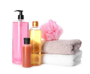 Personal hygiene products with towels and shower puff on white background