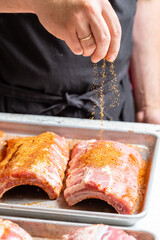 Chef puts spices on the raw piece of meat