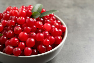 Ripe fresh cranberry on grey table, closeup