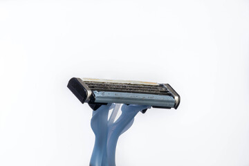 Disposable plastic razor blocked with an accumulation of thick male shaving hairs