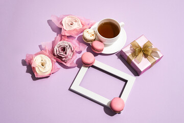 Pink background with tea and roses for March 8