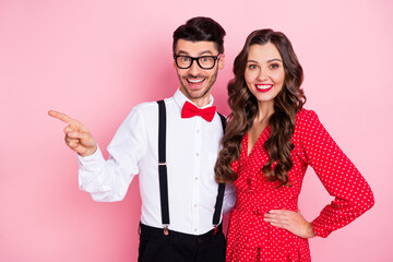 Photo of nice optimistic brown hair couple point empty space wear trend cloth isolated on pastel pink color background