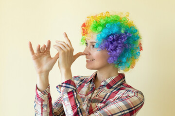 Girl in funny wig fooling around, april fools day concept