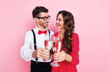 Photo of nice optimistic brown hair couple hold glasses celebrate wear trend cloth isolated on pastel pink color background