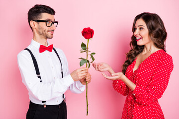 Profile photo of nice optimistic brown hair couple give rose wear dress shirt isolated on pink color background