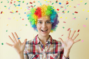 Fototapeta premium Woman in colored wig celebrating fools day, April 1st concept