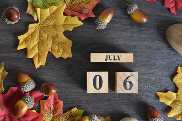 July 6, Cover Date design with Calendar cube decorate with maple leaf and Acorn Oak seed for your...