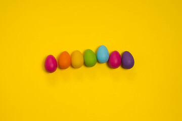 Colored Easter Eggs Isolated on a Yellow Background. Holidays, traditions concept.