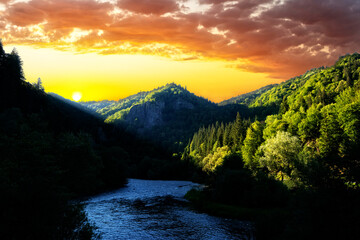 Beautiful sunrise over mountains with colorful sky and a river