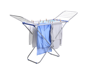 Clean laundry hanging on drying rack against white background