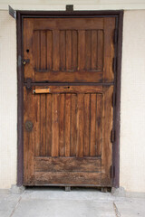 old hardwood double door of a closed stable