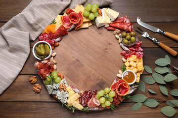 Assorted appetizers served on wooden table, flat lay. Space for text