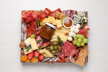 Assorted appetizer served on white wooden table, top view