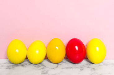 Easter eggs on white marble table against pink background, space for text