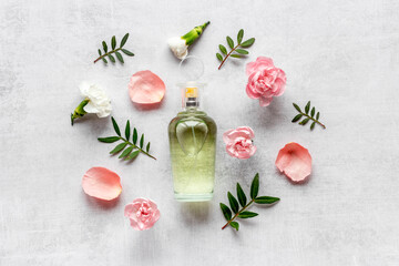 Fototapeta na wymiar Fragrances perfume bottle with flowers, flat lay, top view