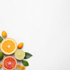 Fresh juicy citrus fruits with green leaves on light background, flat lay. Space for text