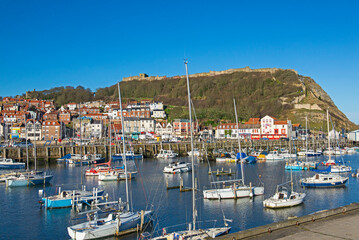 Fototapeta na wymiar Harbor seafront town with castle on hill