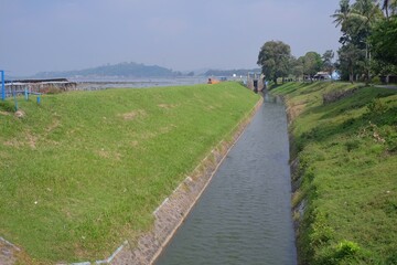 Klaten, Indonesia, March 3, 2021. The flow of heavy river water that comes from the Rowo Jombor reservoir for irrigation canals.