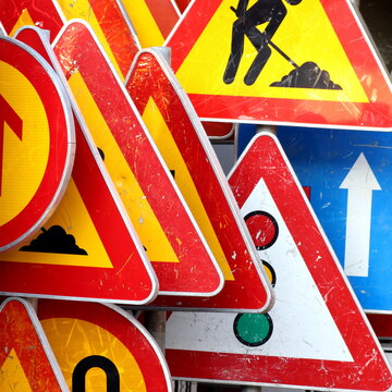 Road And Traffic Signs On The Pile