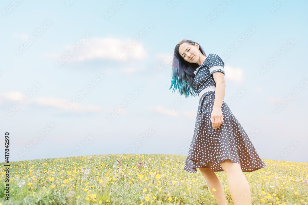 Canvas Prints beautiful young woman with blue hair are walking through the flower fields.