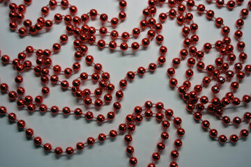 Beautiful red minor Christmas beads for decorating Christmas tree arranged on a white background. 