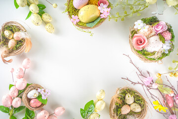 Easter greeting card background. Spring tree decor branches with colorful eggs, flowers and leaves on white background copy space for your text