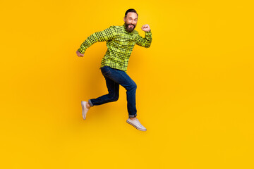 Fototapeta na wymiar Full body profile side photo of man happy positive smile go walk run jump hurry isolated over yellow color background