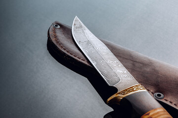 Hunting knife on black background with reflection