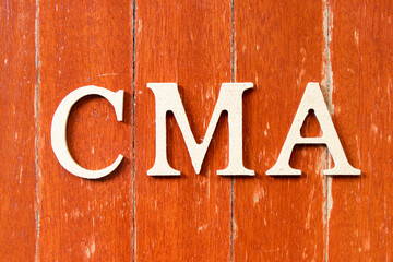 Alphabet letter in word CMA (Abbreviation of Certified management accountant,Competition and markets authority or Certified medical assistant) on old red color wood plate background