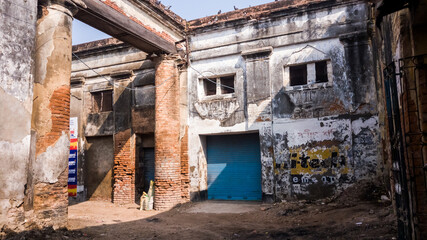 The ruined colonnaded entrance to an old dilapidated market in the town of Murshidabad.